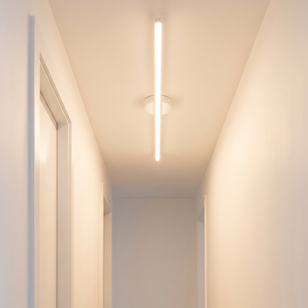 Stride linear light in white, flush to a hallway ceiling