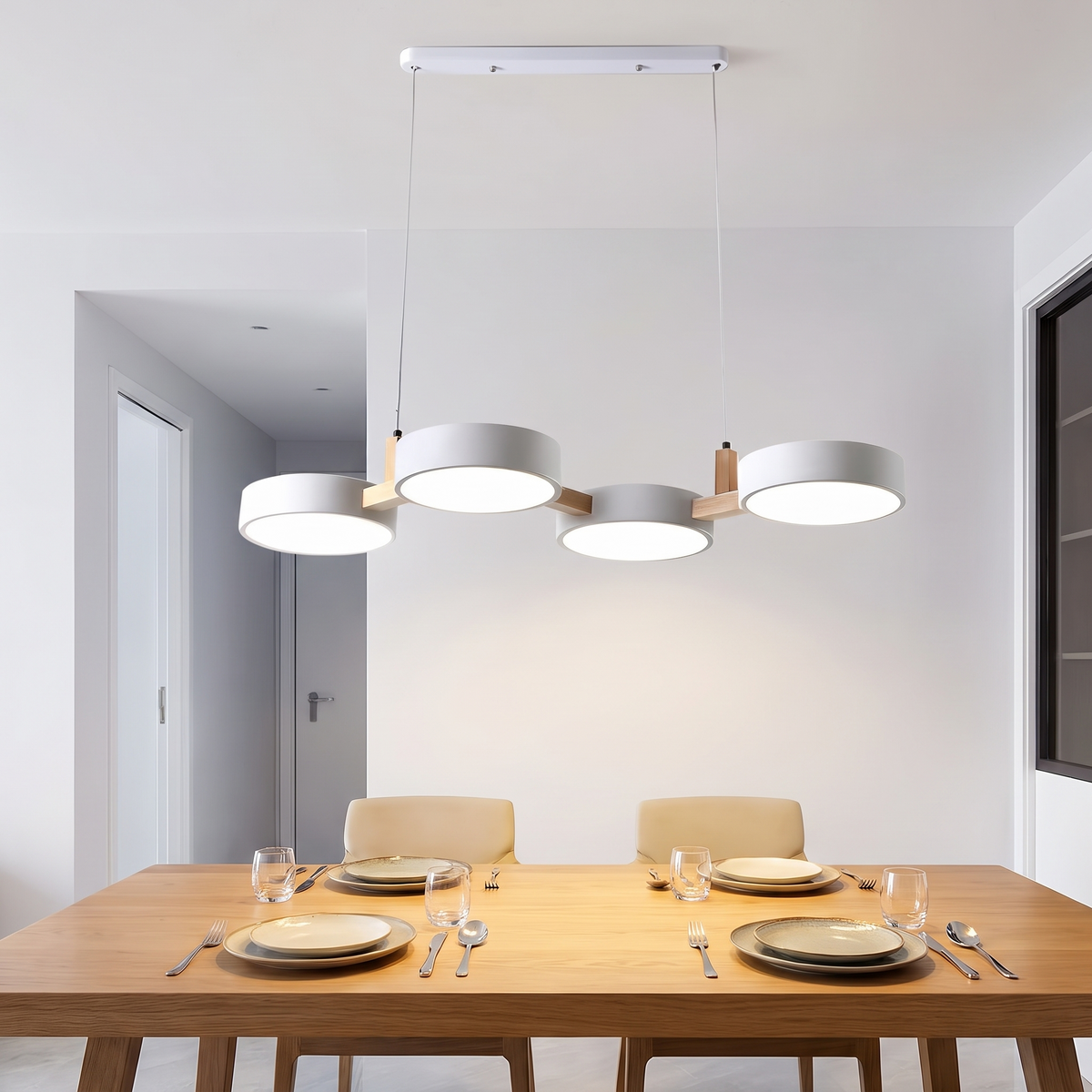 Light from the Tavola pendant falling evenly along a long dining table