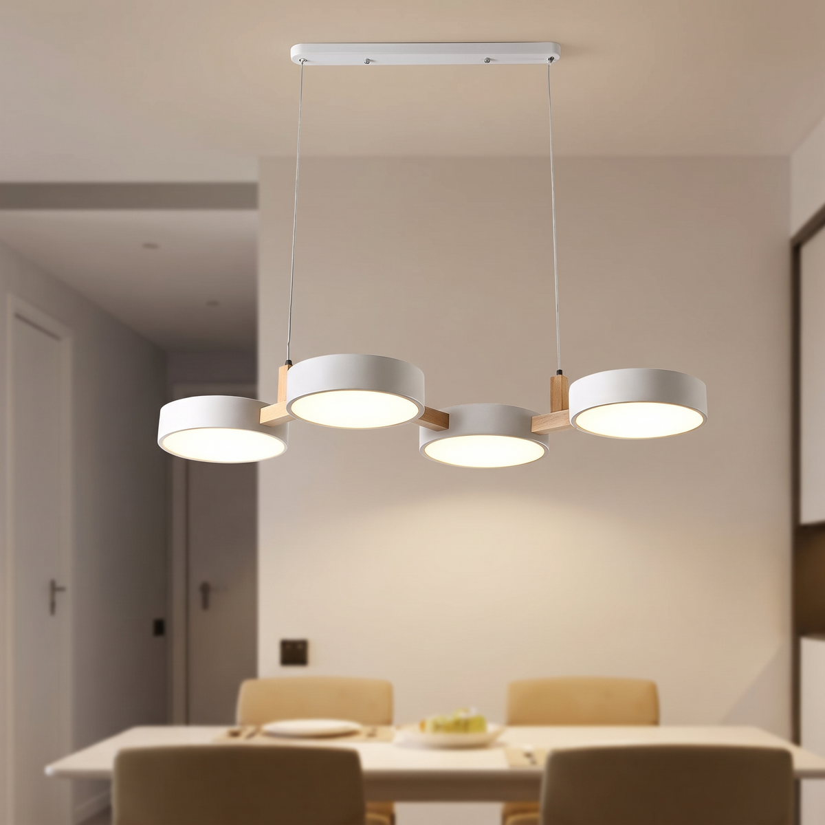 Tavola pendant from seated height, flat diffusers glowing warm without glare