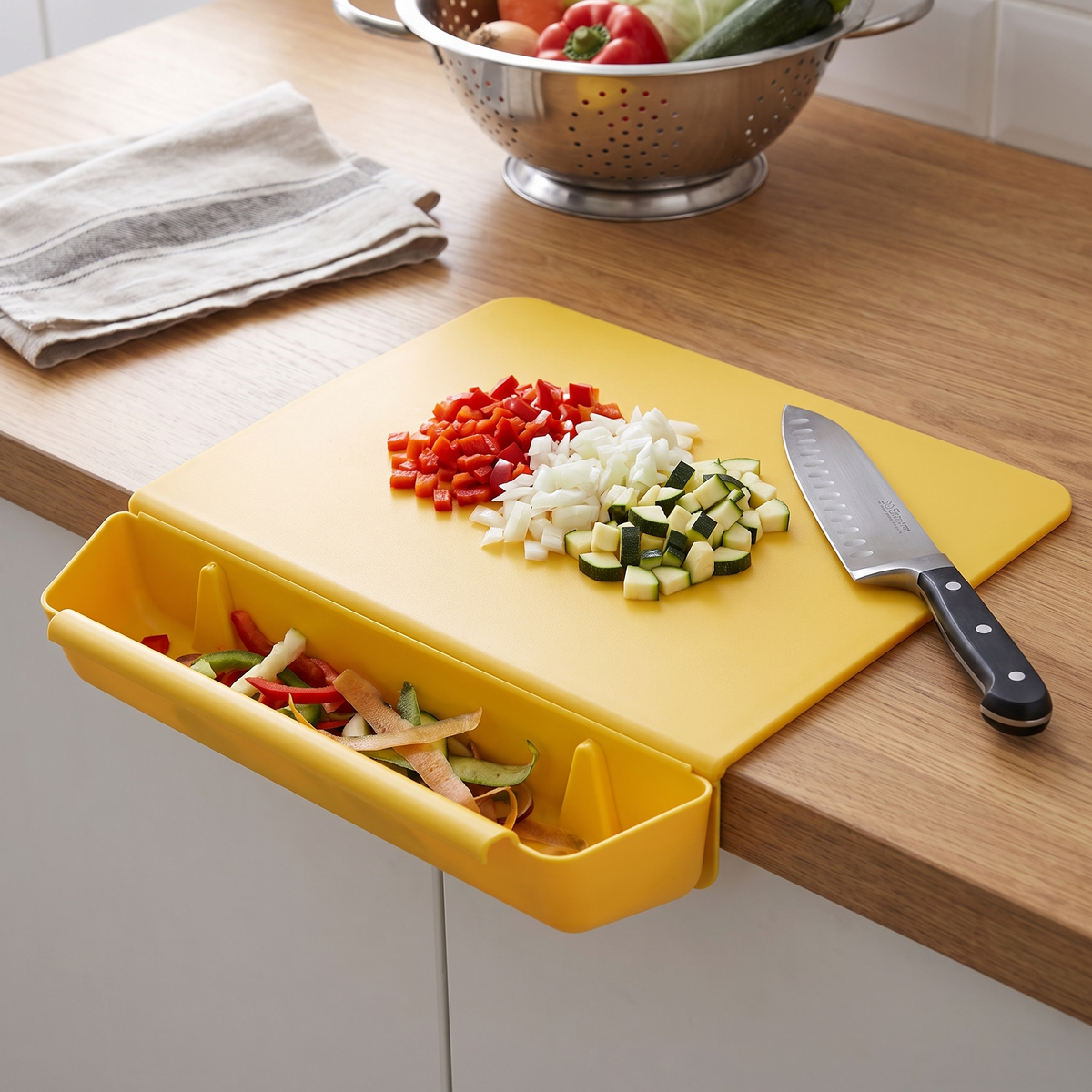 Chopping board over its catch tray mid-prep