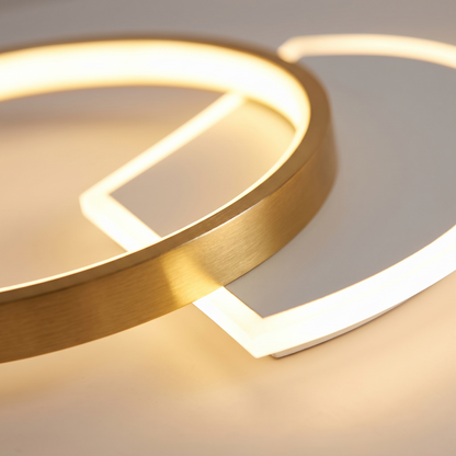 Detail of the brushed gold ring crossing the lit panel on the Orbit ceiling light