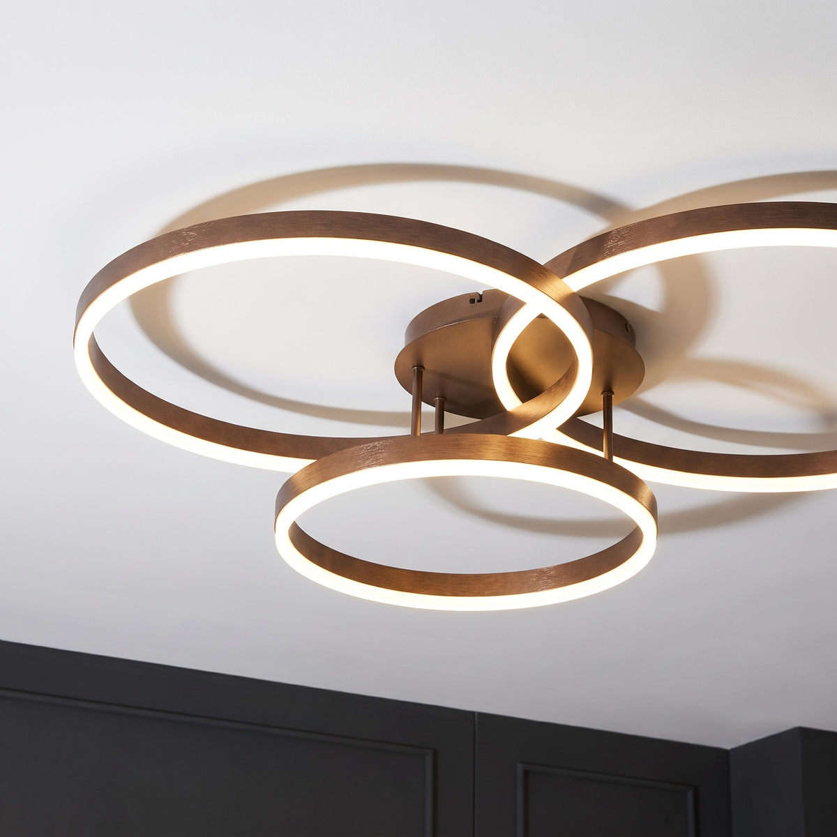 Close view of the Ripple ceiling light showing the three overlapping lit rings