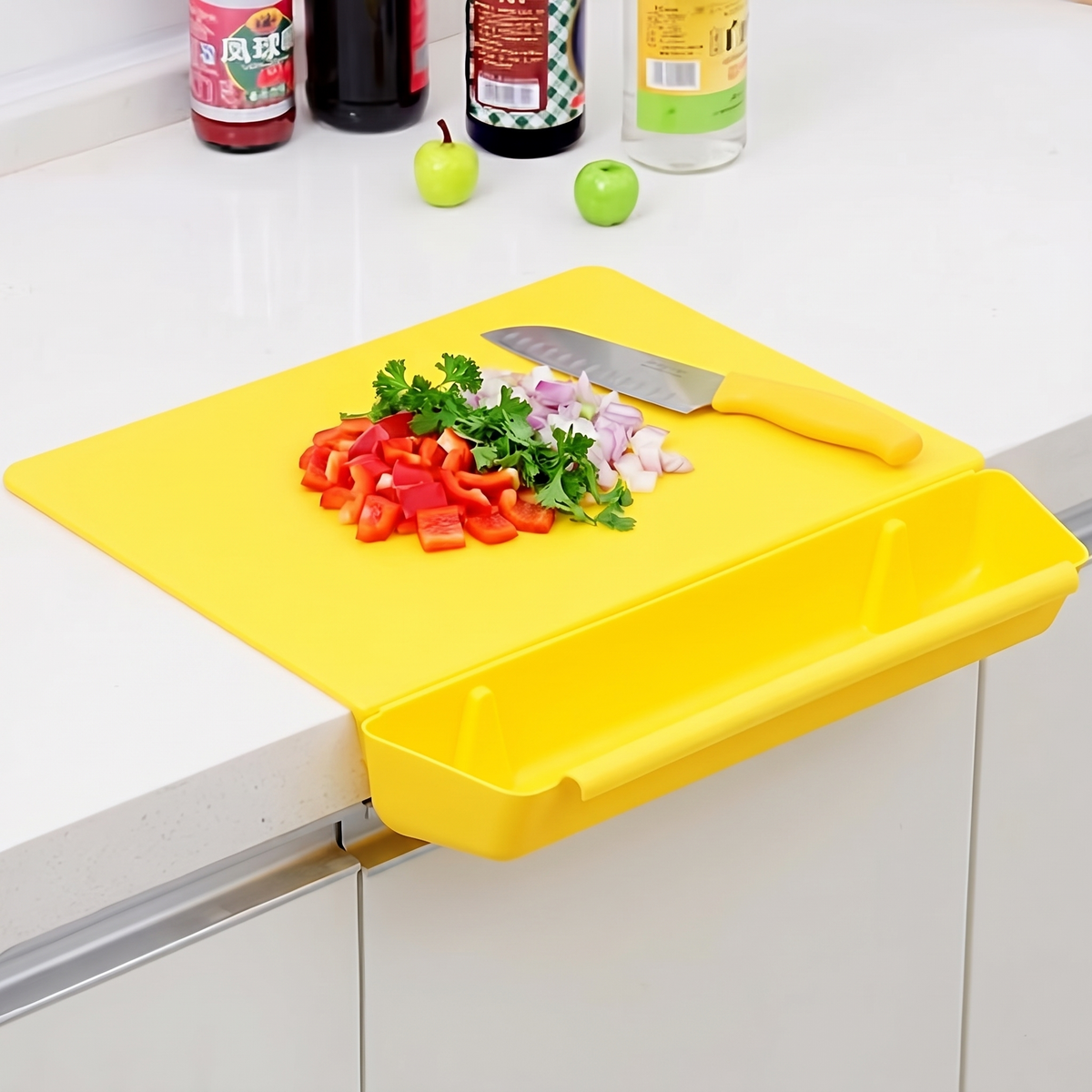 Sweep chopping board in yellow, clamped to a kitchen counter