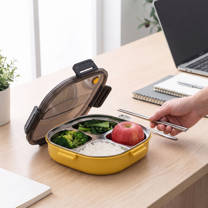 Quartet four-compartment steel lunch tray open on a wooden desk