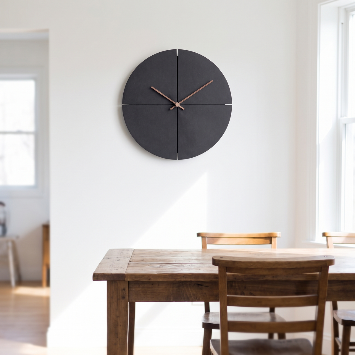 Quarter minimal wall clock in charcoal above a dining table