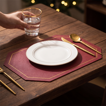 Facet octagonal faux leather placemat in wine red on a walnut table