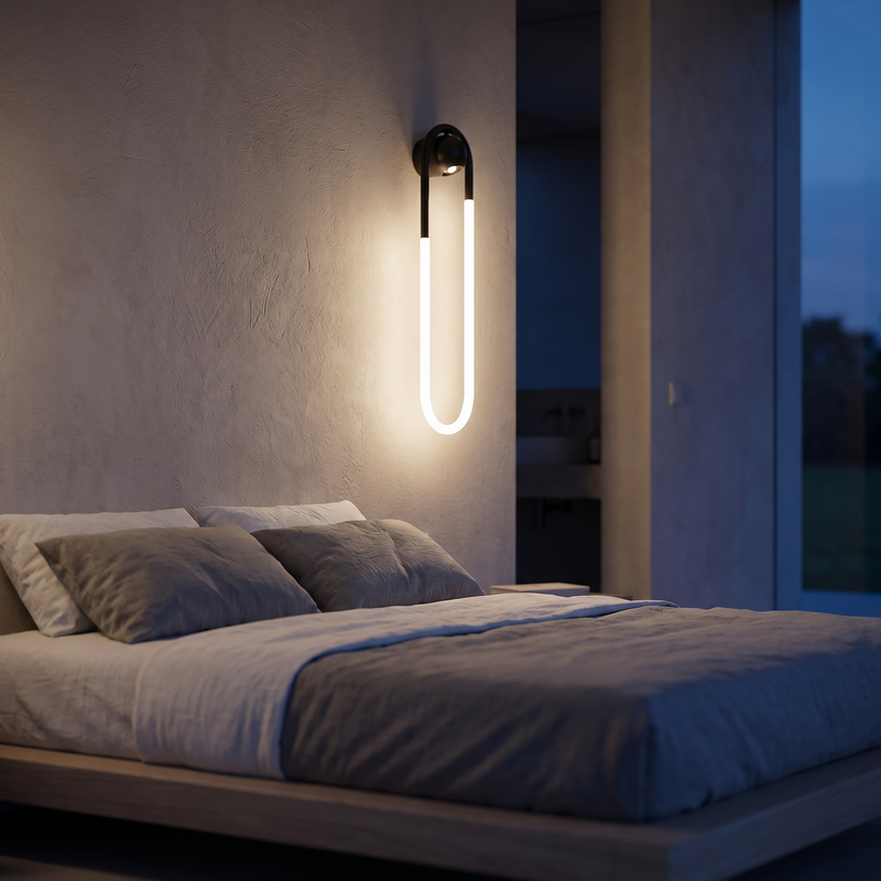 Loop arc wall light glowing above a bed