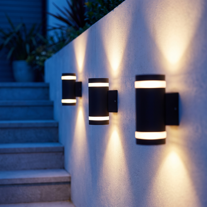 Three Column wall lights along an exterior stairway at night