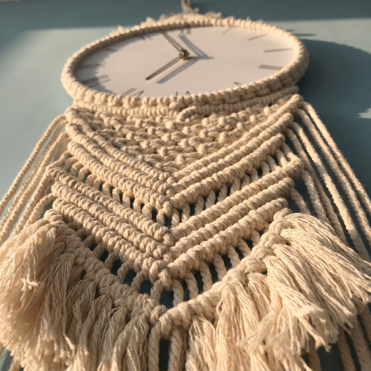 Braid macrame wall clock detail of the knotting around the dial