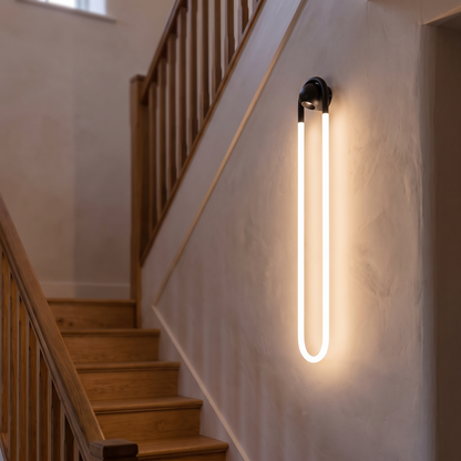 Loop arc wall light lit in a stairwell